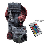 Decorative castle with dragon design and remote control on a white background