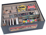 Collection of board game components in a storage box with compartments.