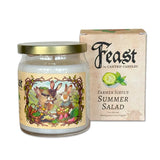 A jar candle with a gold metal lid and a colorful illustrated label, shown next to its kraft paper box. The box reads 'Feast by Cantrip Candles' and 'Farmer Sibyl's Summer Salad'.