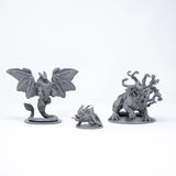 Three gray fantasy creature figurines on a white background