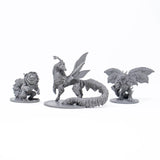Three fantasy creature figurines on white stands against a white background