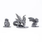Three fantasy creature figurines on white stands against a white background