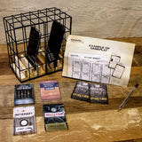 Board game components including cards and a cage on a wooden surface.