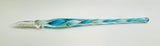 Decorative glass tool with blue and green swirls on a white background