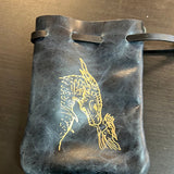 Leather pouch with fish design on a wooden surface