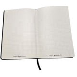 Open notebook with grid pattern on white background