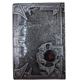 Decorative book with intricate designs and a central emblem on a white background
