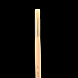 Makeup brush with '2D Glow' text on a black background