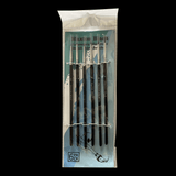 Set of paintbrushes in a clear plastic packaging on a black background