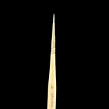 Makeup brush with 'h' marking on a black background