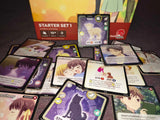 Collection of trading cards with a starter set box in the background
