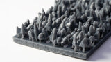 Collection of small gray 3D-printed figures on a white background