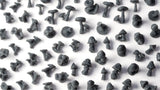Pattern of small gray mushroom figurines on a white background