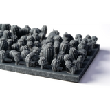 Gray 3D-printed miniature cactus models arranged on a matching gray display tray, photographed on a clean white background.
