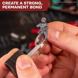Person applying a clear substance to a miniature figure with text 'Create a Strong, Permanent Bond'.