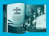 Open book showing a page with 'The Citadel of Scrap' title and a dystopian cityscape illustration.