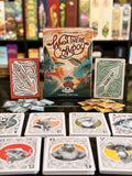 Card game packaging and cards with 'Whoa There Cowboy' branding on a table.