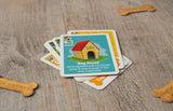 Card game with dog-themed cards on a wooden surface