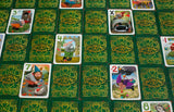 Collection of 'Gnoming Around' game cards on a green patterned surface