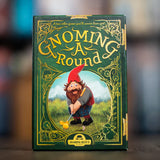 Board game box titled 'Gnoming a Round' with a gnome illustration on a blurred background