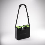 Black and green carrying case with a strap on a gray background
