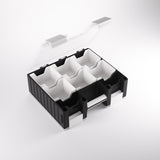 Black and white plastic compartmentalized organizer on a light gray background
