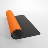 Orange and black yoga mat on a light gray background
