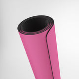 Pink yoga mat with black edge on a white background