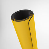 Roll of yellow material with black edge on a white background