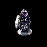 Crystal figurine with purple and silver accents on a black background