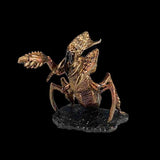 Metallic scorpion figurine on a black background