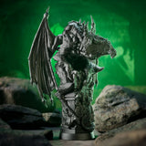 Dragon statue on a rocky surface with a green background