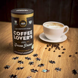 Coffee Lover's Jigsaw Puzzle packaging with a cup of coffee and scattered puzzle pieces on a wooden table.