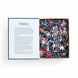 Jigsaw puzzle in a box with a description card on a white background