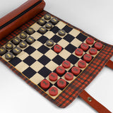 Checkers game set with red and black pieces on a plaid fabric board.