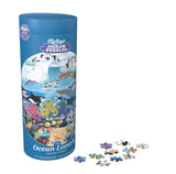 Jigsaw puzzle packaging with ocean-themed illustrations and scattered pieces on a white background