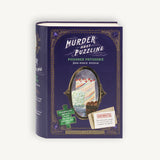 Book-shaped puzzle box with 'Murder Most Puzzling' and 'Poisoned Patisserie' text on a white background