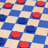 Checkers game in progress on a checkered board with red and blue pieces.