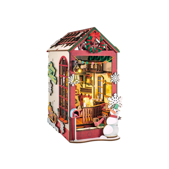 Decorative wooden house with Christmas-themed decorations on a white background