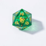 Green polyhedral dice with gold numbers on a light gray background