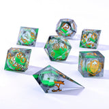 Set of green and gold polyhedral dice on a white background