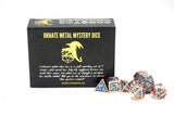 Ornate metal mystery dice set with black box featuring yellow text and logo.