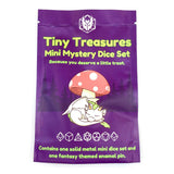 Purple packaging of 'Tiny Treasures Mini Mystery Dice Set' with a cartoon cat and mushroom design.