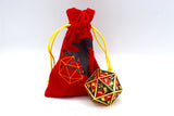 Red drawstring bag with a black and gold polyhedral dice on a white background