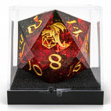 Polyhedral dice with dragon design and gold numbers in a clear display case.