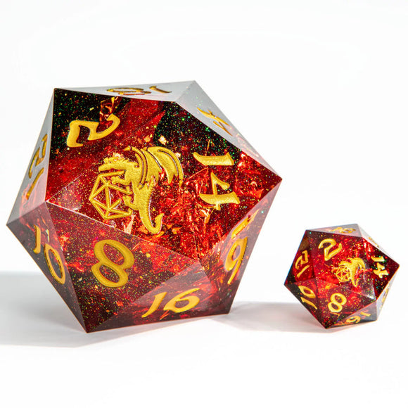 Two polyhedral dice with red and gold glittery finish on a white background