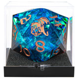 Blue and green polyhedral dice with copper numbers and dragon design in a clear display case.
