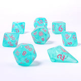 Set of turquoise dice with pink numbers on a white background