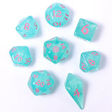 Set of turquoise dice with pink numbers on a white background