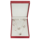 Silver necklace and earrings set in a red box